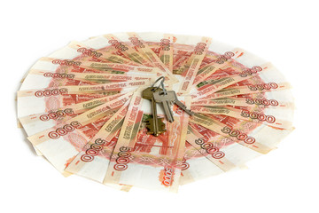 Cash on white background. The keys to the apartment on the money. Bills 5 thousand rubles, spread out like a fan.