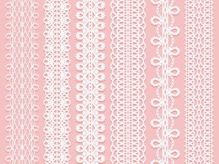 Wide lace ribbons set on a pink background.