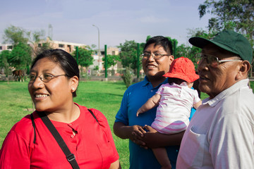 Naklejka premium Native american family of three generations having good time in the summer park.