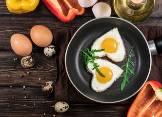 Fried eggs in the form of a heart in a skillet