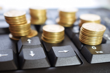 Gold coins on the keyboard, business concept