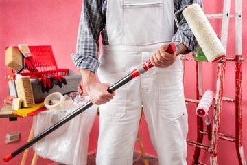 Professional house painter at work on the construction site. © francescomou