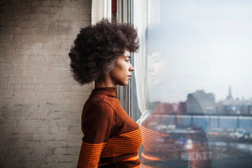 Woman looking through window 