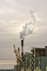 Environmental problem of city air  pollution - Industrial construction cranes and building site...