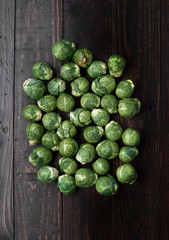 bunch of raw brussels sprouts on rustic wood with natural light