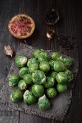 bunch of raw brussels sprouts on rustic wood with natural light