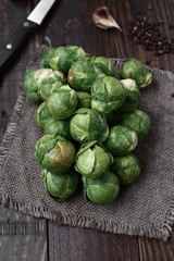 bunch of raw brussels sprouts on rustic wood with natural light