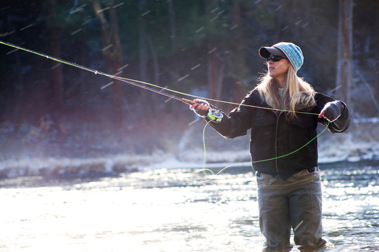 Woman casting fishing line 