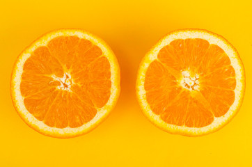 Two halves of cut orange, top view.