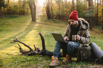 Young blogger photographer travel in mountain forest