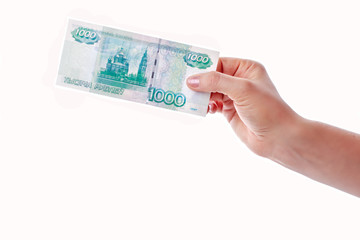 Female hand holding and giving a banknote of one thousand rubles isolated on white background....