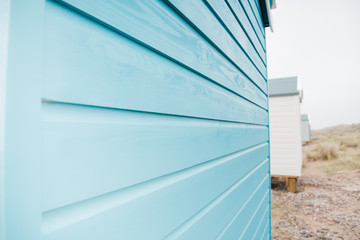 Findhorn, Scotland - July 2016: Colourful beach huts along the coast at Findhorn Bay in Northern Scotland among the sand dunes