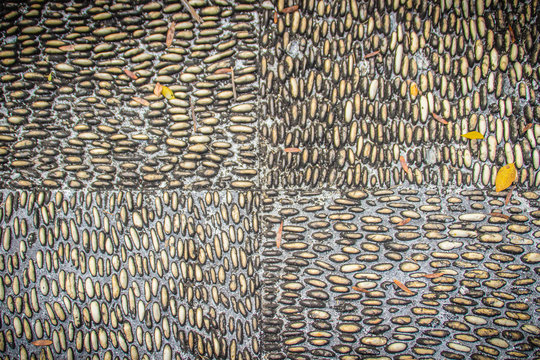 River pebble gravel round stone wall patterned for background. White pebbles background for home and home exterior wall and floor decoration.