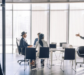 Multicultural business men only of caucasian, indian and arab ethenity meeting and talking about business at modern office with panoramic windows