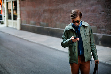 Man checking smartphone in street 