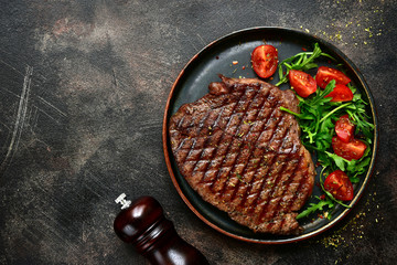 Roasted organic rancho beef steak with vegetables salad.Top view with copy space.