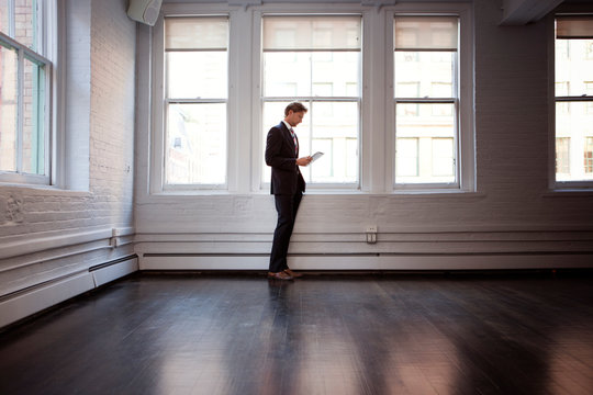 Businessman standing in empty room 