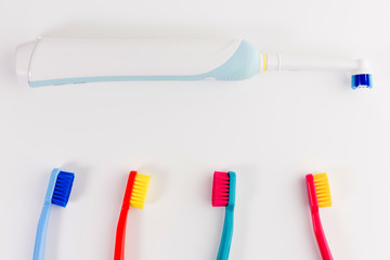 Red, pink, blue and light blue toothbrushes. Taking care of teeth, dental concept. Flat lay photo, copy space, top view