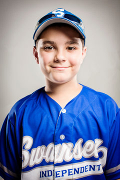 Portrait of young baseball player (8-9) 