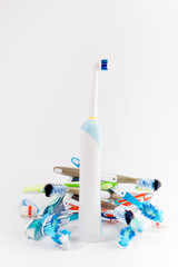 Manual regular Toothbrush Against Modern Electric Toothbrush. Isolated on White Background. Manual used tuthbrushes background