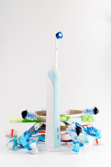 Manual regular Toothbrush Against Modern Electric Toothbrush. Isolated on White Background. Manual used tuthbrushes background
