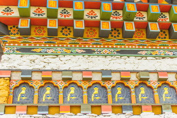 Colorful Bhutan temple roof detail. Beautiful decorations on windows and doors, traditional Bhutanese architecture.