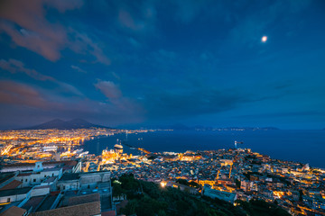 Obraz premium Naples, Italy. Skyline Cityscape In Evening Lighting. Tyrrhenian Sea And Landscape With Volcano Mount Vesuvius. City In Night Illuminations