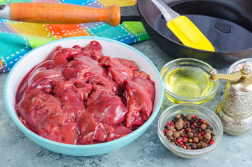 Raw chicken liver for cooking, spices, oil.