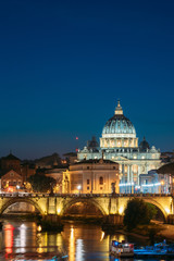 Fototapeta na wymiar Rome, Italy. Papal Basilica Of St. Peter In The Vatican And Aelian Bridge In Evening Night Illuminations