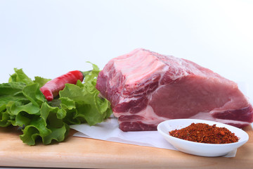 Raw pork chops with herbs and spices on cutting board. Ready for cooking.
