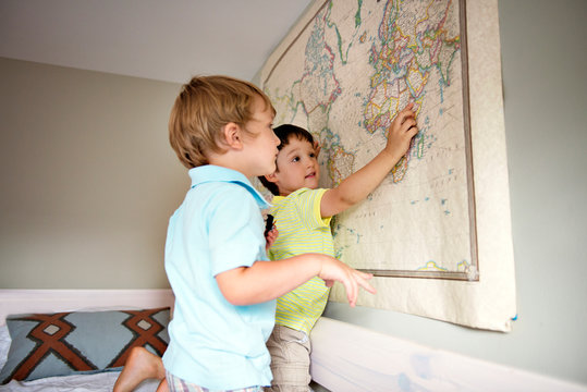 Two boys (2-3, 4-5) playing with map 