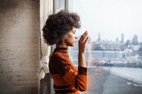 Woman looking through window 