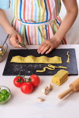 Step by step recipe of italian ravioli with potato filling. Step 6. Woman cooking traditional homemade Italian food concept