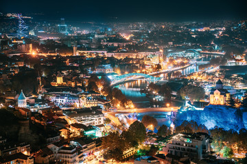Fototapeta na wymiar Tbilisi, Georgia. Top View Of Georgian Capital City Skyline Cityscape In Night Illuminations