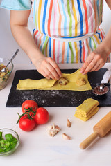 Step by step recipe of italian ravioli with potato filling. Step 3.Woman cooking traditional homemade Italian food concept