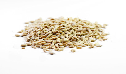 Natural shelled sunflower seeds over white background.