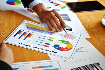 Business concepts, summary documents and brainstorming sessions A group of young businessmen are...