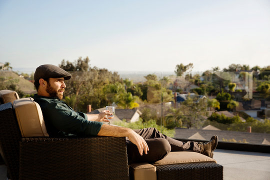 Man relaxing in armchair on patio 