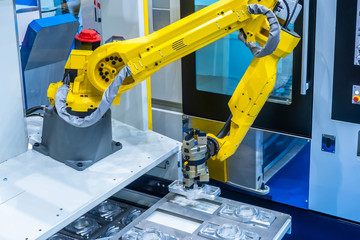 The robot arm. Manipulator puts the parts in the machine..Robotic technology. Automation of...