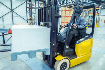 Forklift operator. Forklift stock. The loader lifts the metal box. Unloading goods. Warehousing. Warehouse storage. Logistics in stock.