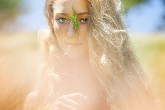 Portrait of young woman in field 