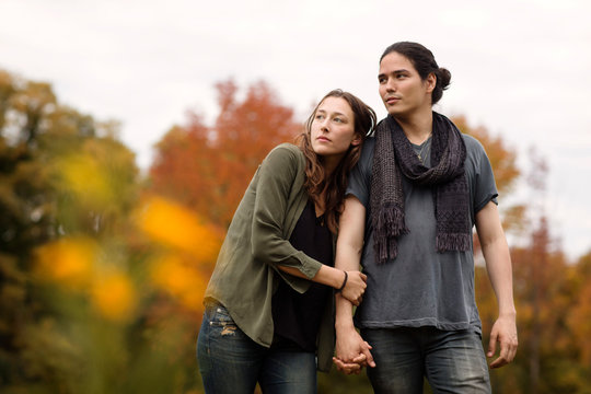 Couple standing and looking away in park 