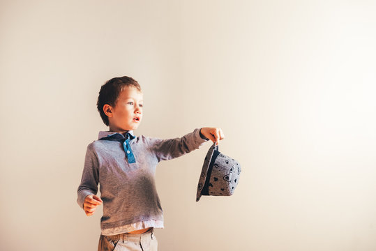 Nice and handsome boy with an elegant hat, isolated background in blaco with copy space.