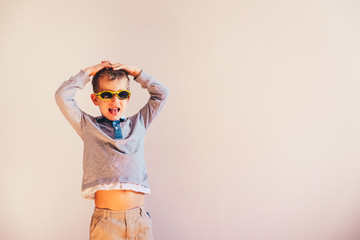 Child having fun gesturing and dancing, on white background and copy space.