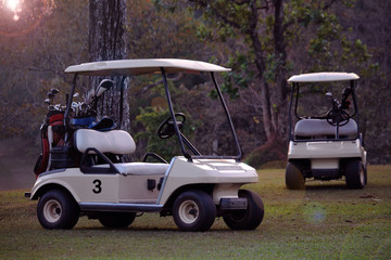 Golfcar in beautiful golf course in the evening golf course with sunshine