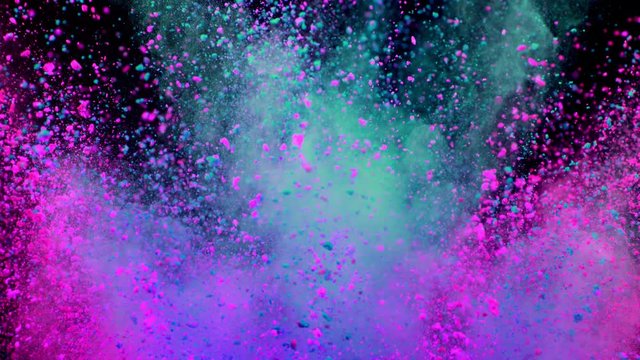 Super slowmotion shot of color powder explosion isolated on black background.