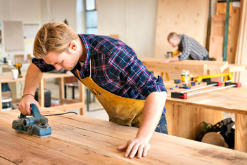 Mid adult men working in carpentry workshop 
