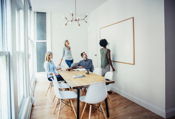 Businesspeople looking at whiteboard 
