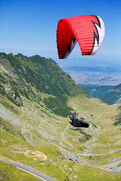 Man parachuting over valley 