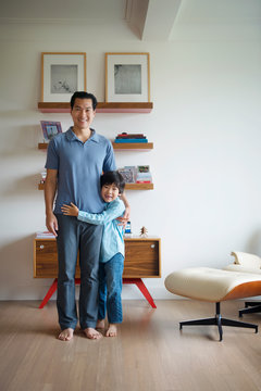 Portrait of boy and father in living room 